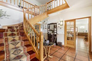 a wooden staircase in a living room with a table at Quintinha d´Avó in Vila de Prado