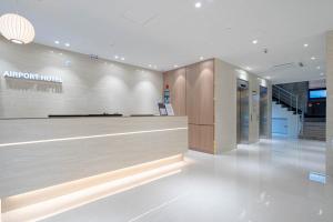 a lobby of an airport hotel with a reception desk at Hotel Airport in Busan