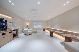 a large living room with a couch and a television at Hotel Airport in Busan