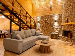 a living room with a couch and a fireplace at Green Olive Luxury Villas in Paliouri +91 photos