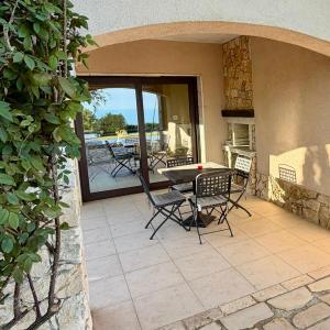 a patio with a table and chairs on a patio at Luxury villas and golf GV6 in Balchik