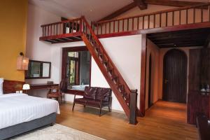 a bedroom with a loft bed and a staircase at ALy's Sapa in Tả Van