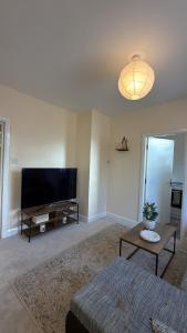 a living room with a large flat screen tv at Cloud Quarters 4 in Huddersfield +5 photos