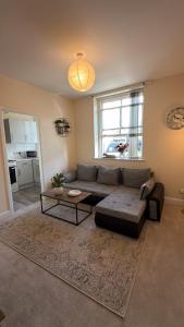 a living room with a couch and a table at Cloud Quarters 4 in Huddersfield