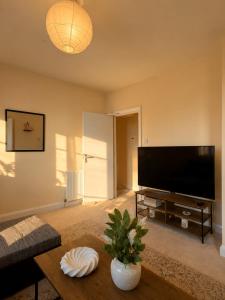 a living room with a large flat screen tv at Cloud Quarters 4 in Huddersfield