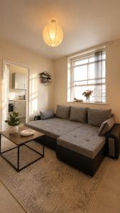 a living room with a large couch and a table at Cloud Quarters 4 in Huddersfield