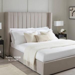 a bedroom with a large bed with white sheets and pillows at شقق القنفذة بلس in Al Qunfudhah