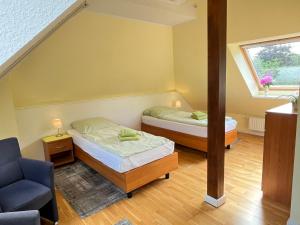 a room with two beds and a chair in it at Schloms Hof in Waffensen +77 photos