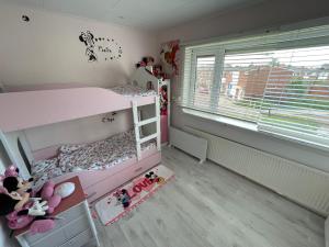 a bedroom with a pink bunk bed and a window at SB villa house in Vlissingen