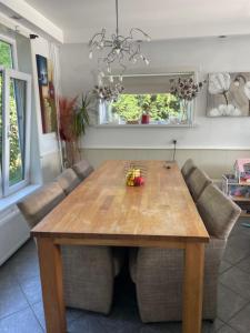 a dining room with a wooden table and chairs at SB villa house in Vlissingen