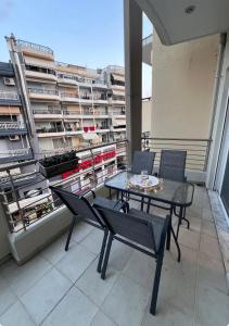 a patio with a table and chairs on a balcony at Ariadnes cosy apartment- walk everywhere in Alexandroupoli