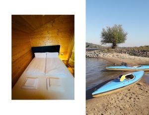 a boat with a bed and a surfboard on the beach at 206 The tiny "Office" House in Bleckede