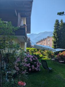 a garden with pink flowers and a building at Bergblick in Schwaz