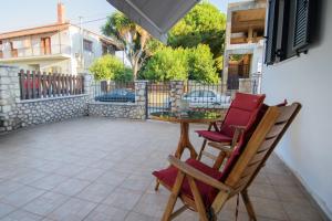 a patio with two chairs and a table at Grimihome 2 in Filiatra
