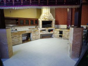 a large kitchen with a stone oven in the middle at Green house eco hotel Samarkand in Samarkand