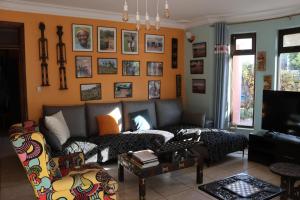 a living room with a couch and a tv at Umusambi B&B in Kigali