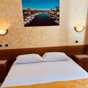 a bedroom with a bed with two pillows on it at Sogno Sulcitano Masainas in Masainas