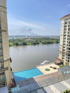 a view of a river between two buildings at Blue Cove Riverine Diamond Kuching in Kuching