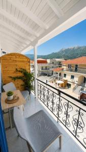 a balcony with a table and chairs and a view at Thelxis Room in Nydri