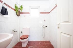 a bathroom with a toilet and a sink at Artemis Breeze in Artemida +26 photos