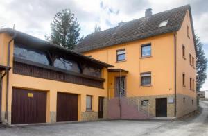 an orange building with a balcony on the side of it at Gemütliche Wohnung am Main 1 in Gemünden