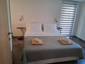 a bedroom with a bed with two towels on it at Apartman Golden Stone in Ivanica