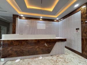 a lobby with a counter in a room with a ceiling at SANTHOSH RESIDENCy in Chengalpattu