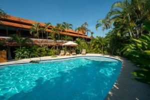 a swimming pool in front of a resort at Uns Hotel - Bali in Legian