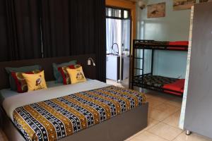 a bedroom with a bed and a bunk bed with a ladder at Umusambi B&B in Kigali +99 photos