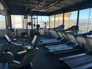 a gym with rows of treadmills and machines at Sol Alphaville Flat Equipado lazer e trabalho in Barueri