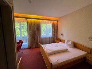 a hotel room with a bed and a window at Das Alpina in Bad Reichenhall