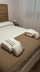 a bed with two towels sitting on top of it at Espejo del mar in Mojácar +8 photos