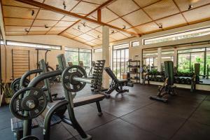 a gym with several treadmills and cardio machines at Arcana Wellness Center - Adults Only in Ko Phangan