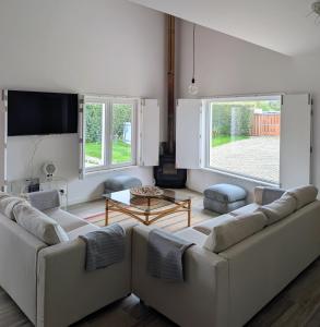 a living room with two couches and a tv at Casa do Tonel in Sagres