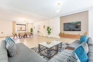 a living room with a couch and a table at Villa Horizon Premium - Private Pool - Fully Renovated - Marrakech in Marrakesh