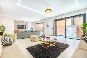 a living room with a couch and a table at Villa Horizon Premium - Private Pool - Fully Renovated - Marrakech in Marrakesh
