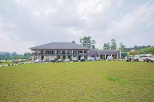 ein großes Gebäude mit einem großen Feld davor in der Unterkunft FortBreeze Hotel in Fort Portal