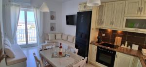 a kitchen and living room with a table and chairs at Naxian Scenery in Glinado Naxos