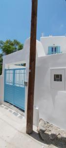 a blue door on a white building with a pole at Naxian Scenery in Glinado Naxos