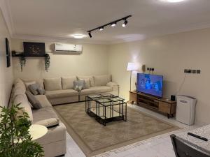 a living room with a couch and a tv at ترف in Medina