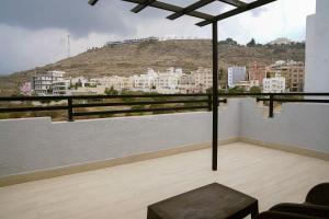 a living room with a view of a city at Pherbion Hotel Apartment Abha in Abha