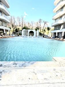 a large swimming pool in front of a building at Rezidenca Onda in Lezhë