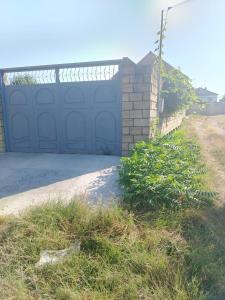 a garage with a blue garage door on a house at Istisu in Müqtǝdir +7 photos