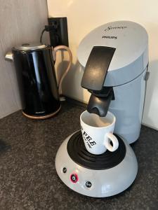 a coffee maker is making a cup of coffee at Casa bosrust anloo in Anloo