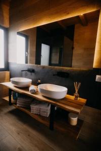 two sinks on a wooden counter in a bathroom at Cabana Stil A in Mărişel +31 photos