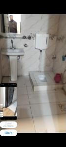 a bathroom with a sink and a toilet at Hayatabad Heights1 in Peshawar
