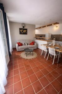 a living room with a couch and a table at Ti Repos - Appartement 2/4 pers| Petit-Havre | Parking in Mare Gaillard +26 photos
