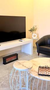 a living room with a couch and a table with a chessboard at In The Peaks in Sharīyah