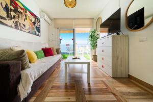 a living room with a couch and a table at Incredible Sunsets in Puerto Rico de Gran Canaria