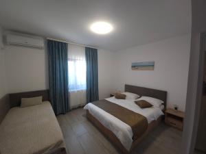 a hotel room with a bed and a window at Vila La Fernando in Tuzla